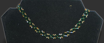 Green and gold Xs necklace.