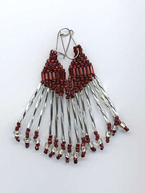 Long red and silver earrings.
